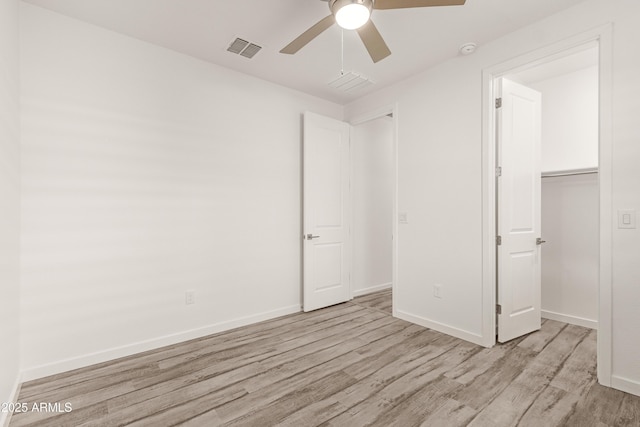 unfurnished bedroom featuring light hardwood / wood-style floors, a closet, and ceiling fan