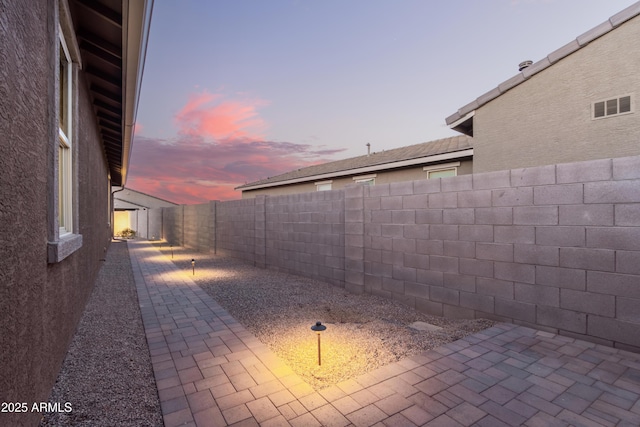 view of patio terrace at dusk