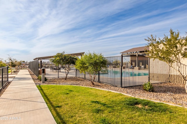 surrounding community featuring a swimming pool and a lawn