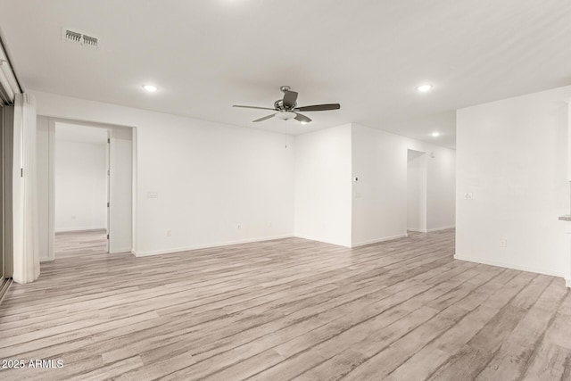 spare room featuring light wood-type flooring and ceiling fan