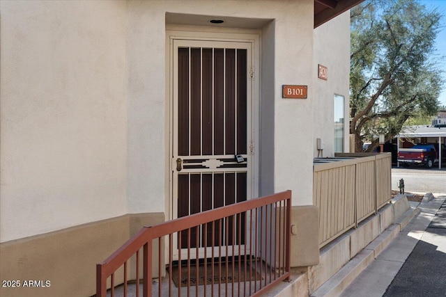 doorway to property with stucco siding