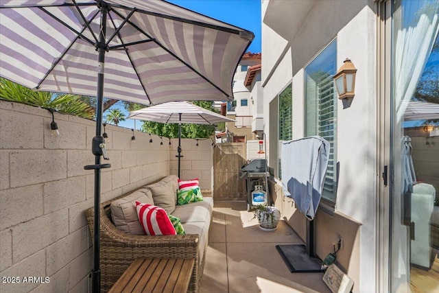 view of patio featuring an outdoor living space and fence