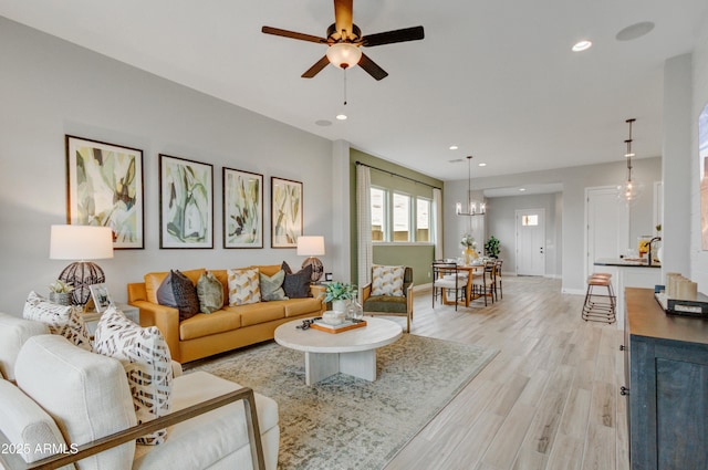 19420 W San Juan Ave, Litchfield Park, AZ 85340 - living room with light wood-style floors, recessed lighting, a ceiling fan, a chandelier, and baseboards