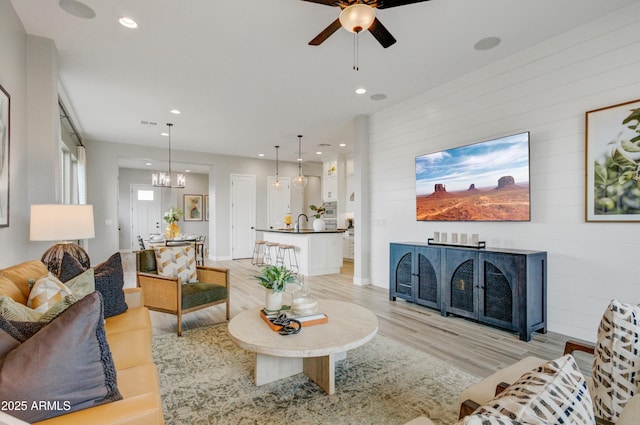 19420 W San Juan Ave, Litchfield Park, AZ 85340 - living room with a chandelier, ceiling fan, light wood-type flooring, and recessed lighting