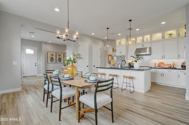 19420 W San Juan Ave, Litchfield Park, AZ 85340 - dining area featuring light wood-style flooring, recessed lighting, a chandelier, and baseboards
