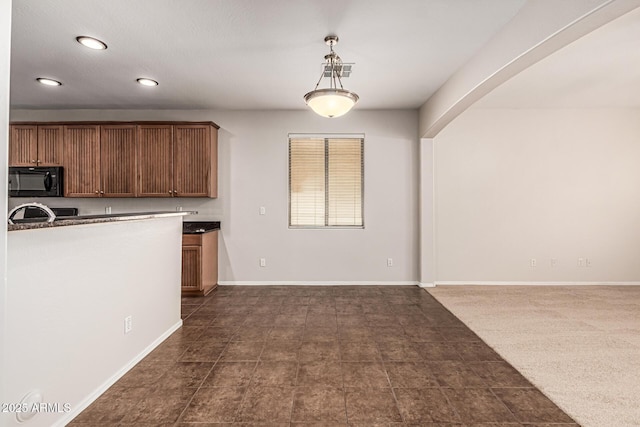 6826 W St Charles Ave, Laveen, AZ 85339 - kitchen featuring black microwave, recessed lighting, decorative light fixtures, brown cabinetry, and arched walkways