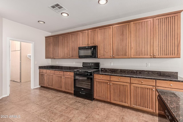 6826 W St Charles Ave, Laveen, AZ 85339 - kitchen featuring black appliances, dark stone countertops, light tile patterned floors, and recessed lighting