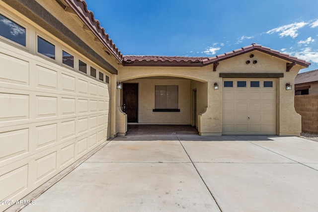 6826 W St Charles Ave, Laveen, AZ 85339 - view of front facade with concrete driveway, a tile roof, stucco siding, and a garage