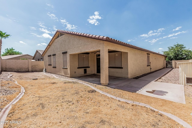 6826 W St Charles Ave, Laveen, AZ 85339 - rear view of house featuring a patio, a fenced backyard, stucco siding, and a tile roof