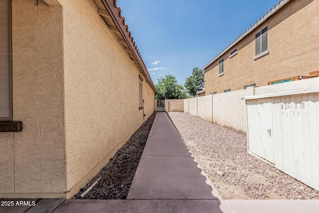 6826 W St Charles Ave, Laveen, AZ 85339 - view of side of property featuring stucco siding and a fenced backyard