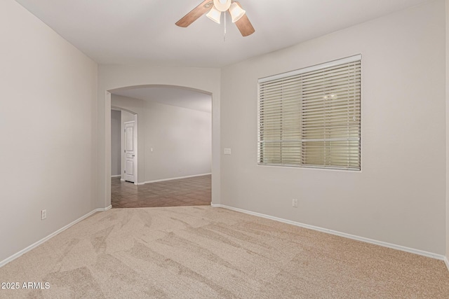6826 W St Charles Ave, Laveen, AZ 85339 - empty room with arched walkways, ceiling fan, and carpet floors