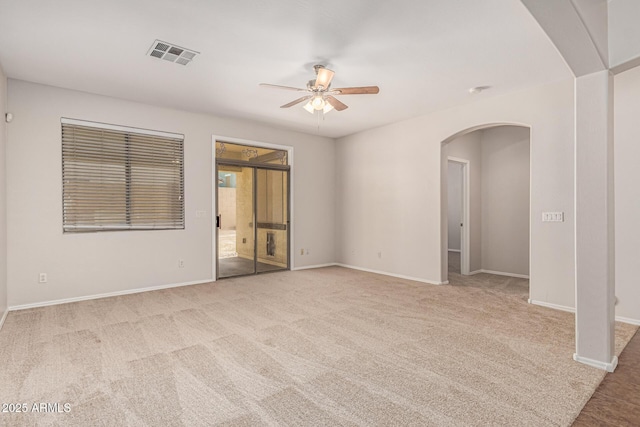 6826 W St Charles Ave, Laveen, AZ 85339 - spare room featuring arched walkways, ceiling fan, and light carpet