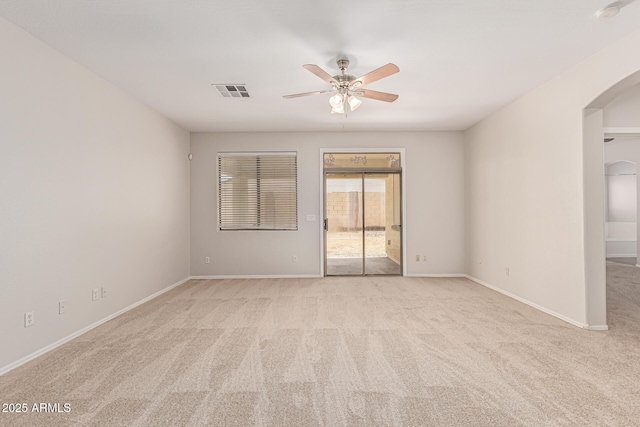 6826 W St Charles Ave, Laveen, AZ 85339 - unfurnished room with arched walkways, light carpet, ceiling fan, and a smoke detector
