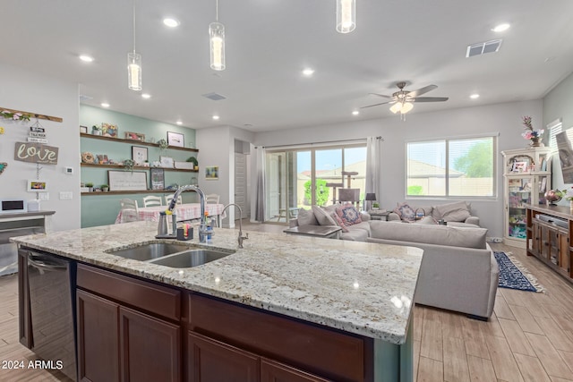 kitchen featuring light wood-type flooring, a wealth of natural light, sink, and ceiling fan