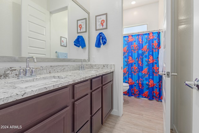 bathroom with vanity, toilet, a shower with curtain, and hardwood / wood-style floors