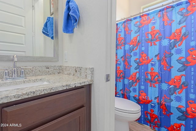 bathroom featuring hardwood / wood-style floors, a shower with curtain, toilet, and vanity