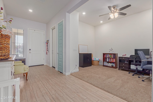 carpeted office featuring ceiling fan