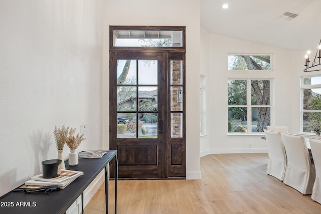 entryway featuring plenty of natural light, a notable chandelier, and light hardwood / wood-style floors