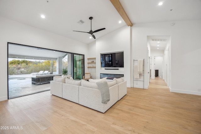 unfurnished living room with beamed ceiling, ceiling fan, high vaulted ceiling, and light hardwood / wood-style flooring