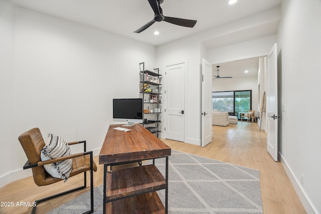 office with ceiling fan and light hardwood / wood-style floors