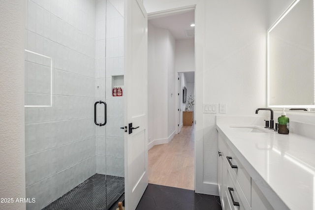 bathroom featuring vanity, tile patterned floors, and a shower with door