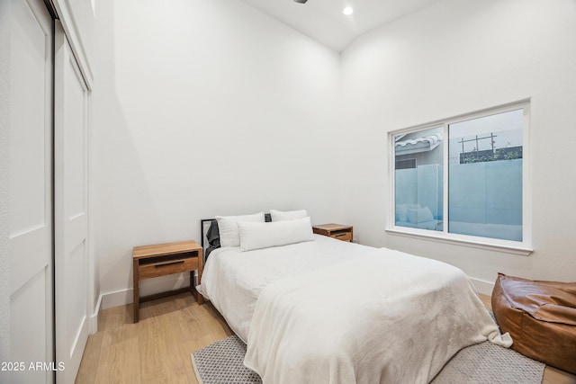 bedroom with a closet and light hardwood / wood-style flooring