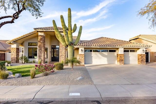 mediterranean / spanish home with a garage