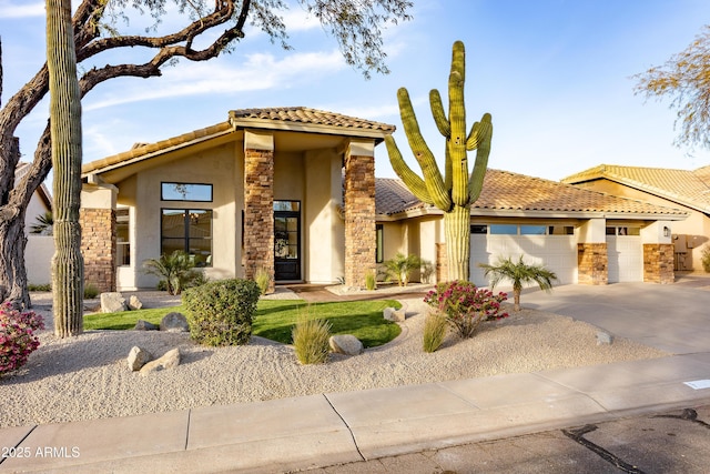 mediterranean / spanish home featuring a garage