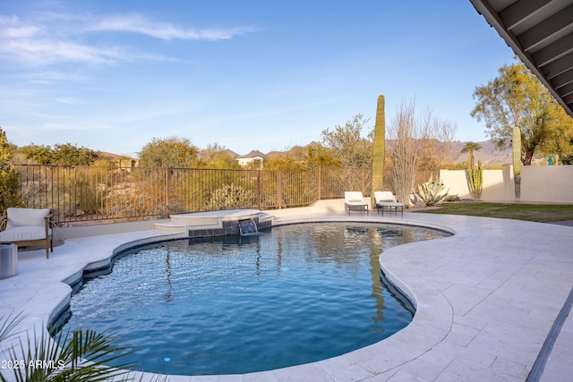 view of swimming pool with an in ground hot tub and a patio area