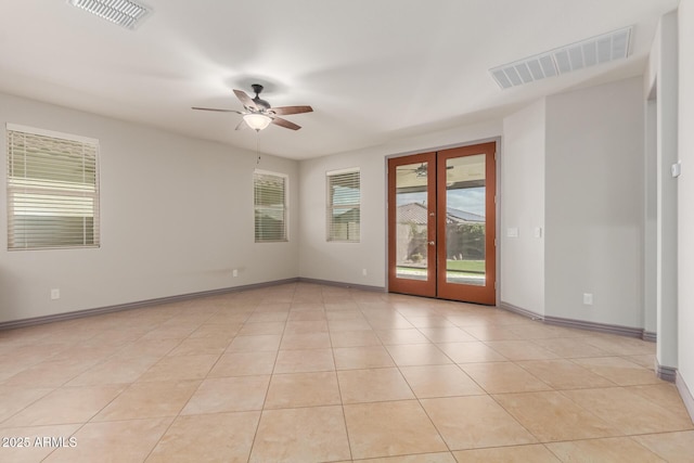 empty room featuring french doors, a ceiling fan, light tile patterned floors, and visible vents