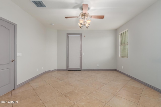 unfurnished room with light tile patterned flooring, baseboards, ceiling fan, and visible vents