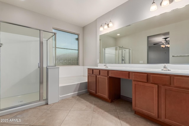 bathroom featuring a shower stall, tile patterned floors, double vanity, and a sink
