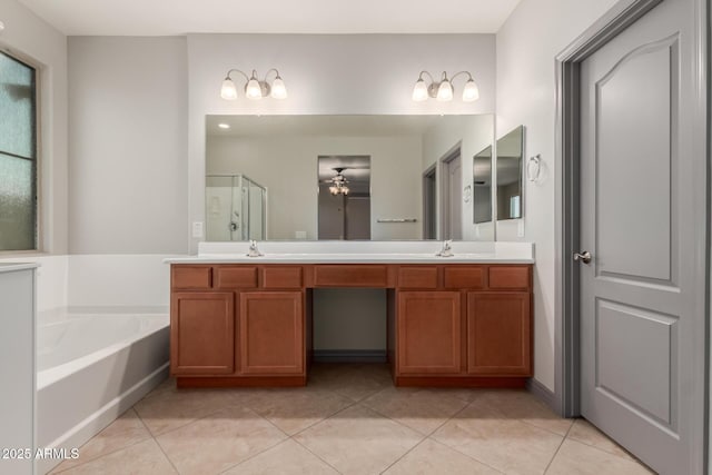 bathroom with ceiling fan, a garden tub, tile patterned flooring, and a shower stall