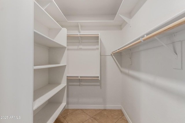 walk in closet with tile patterned flooring
