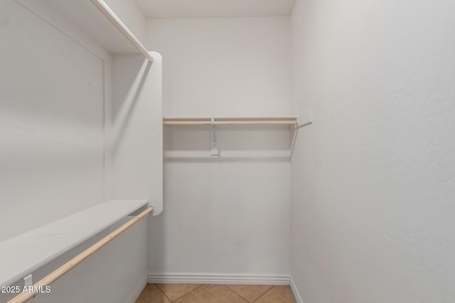spacious closet featuring light tile patterned flooring