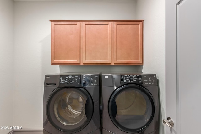 clothes washing area with cabinet space and washer and dryer