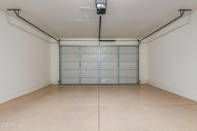 garage with a garage door opener and baseboards