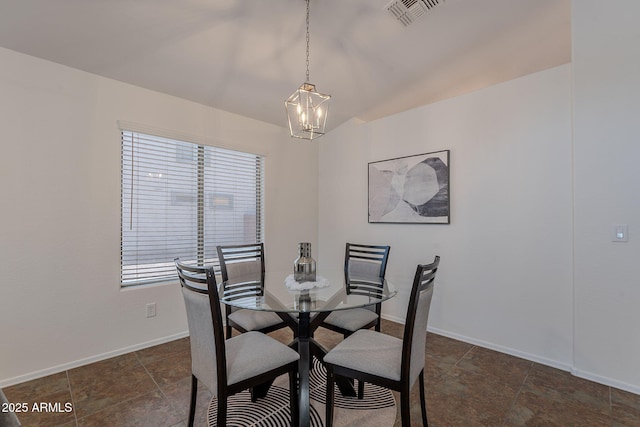 dining room with a chandelier and baseboards