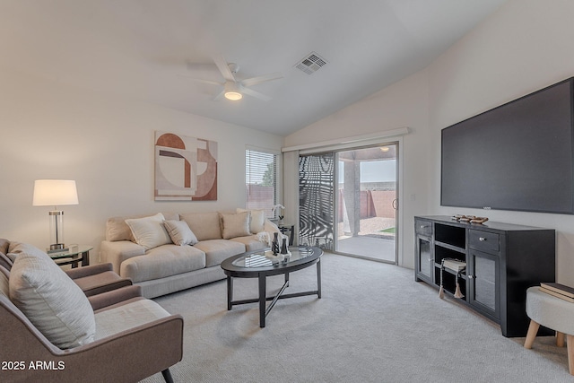 living room featuring lofted ceiling, ceiling fan, and light carpet