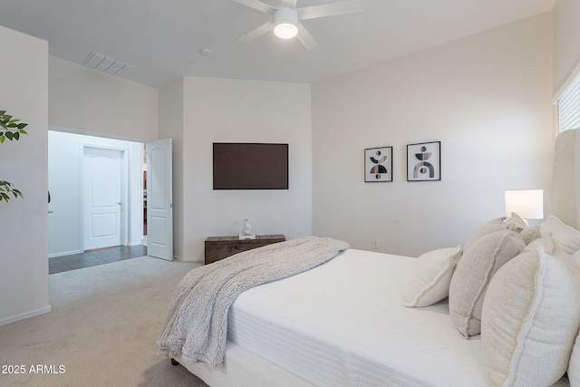 bedroom with light colored carpet, a ceiling fan, and baseboards