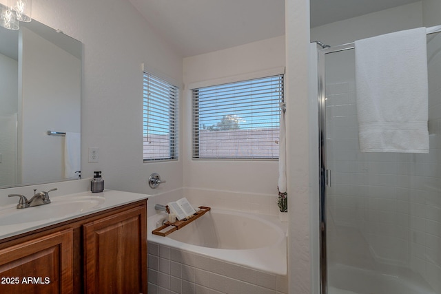 full bathroom with a shower stall, vanity, and a bath