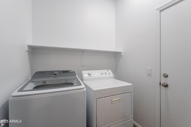 laundry area with independent washer and dryer