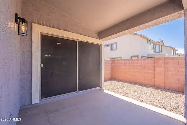 view of patio featuring fence