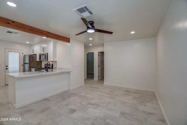 kitchen with kitchen peninsula, ceiling fan, stainless steel appliances, white cabinetry, and light tile floors