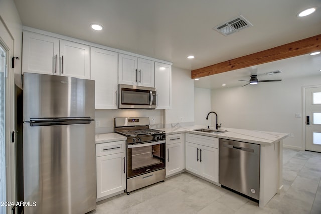 kitchen featuring appliances with stainless steel finishes, ceiling fan, sink, light tile flooring, and kitchen peninsula