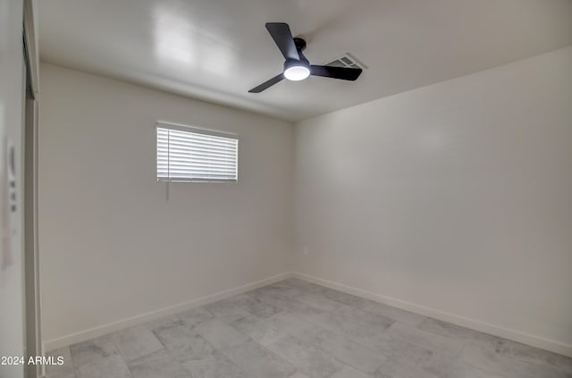 spare room featuring ceiling fan and light tile flooring