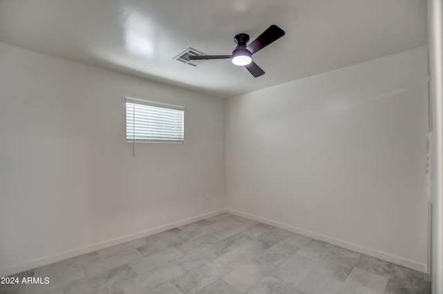 empty room with ceiling fan and light tile floors