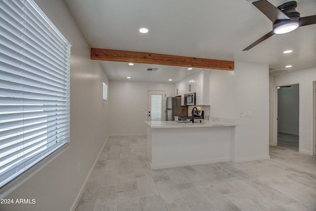 kitchen featuring light tile flooring, white cabinetry, kitchen peninsula, stainless steel appliances, and ceiling fan