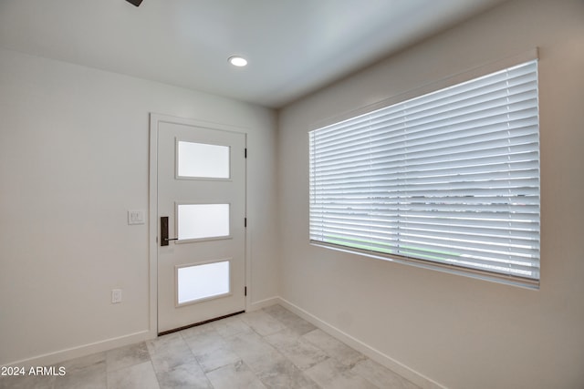 entrance foyer with light tile floors and a wealth of natural light