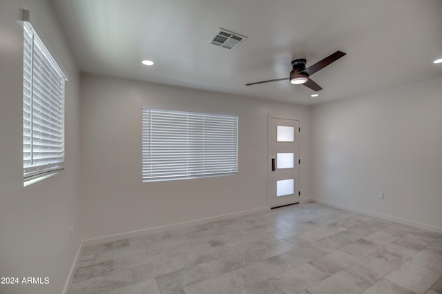 unfurnished room featuring ceiling fan and light tile flooring